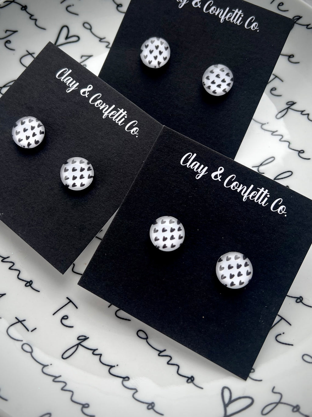 White with black hearts glass stud