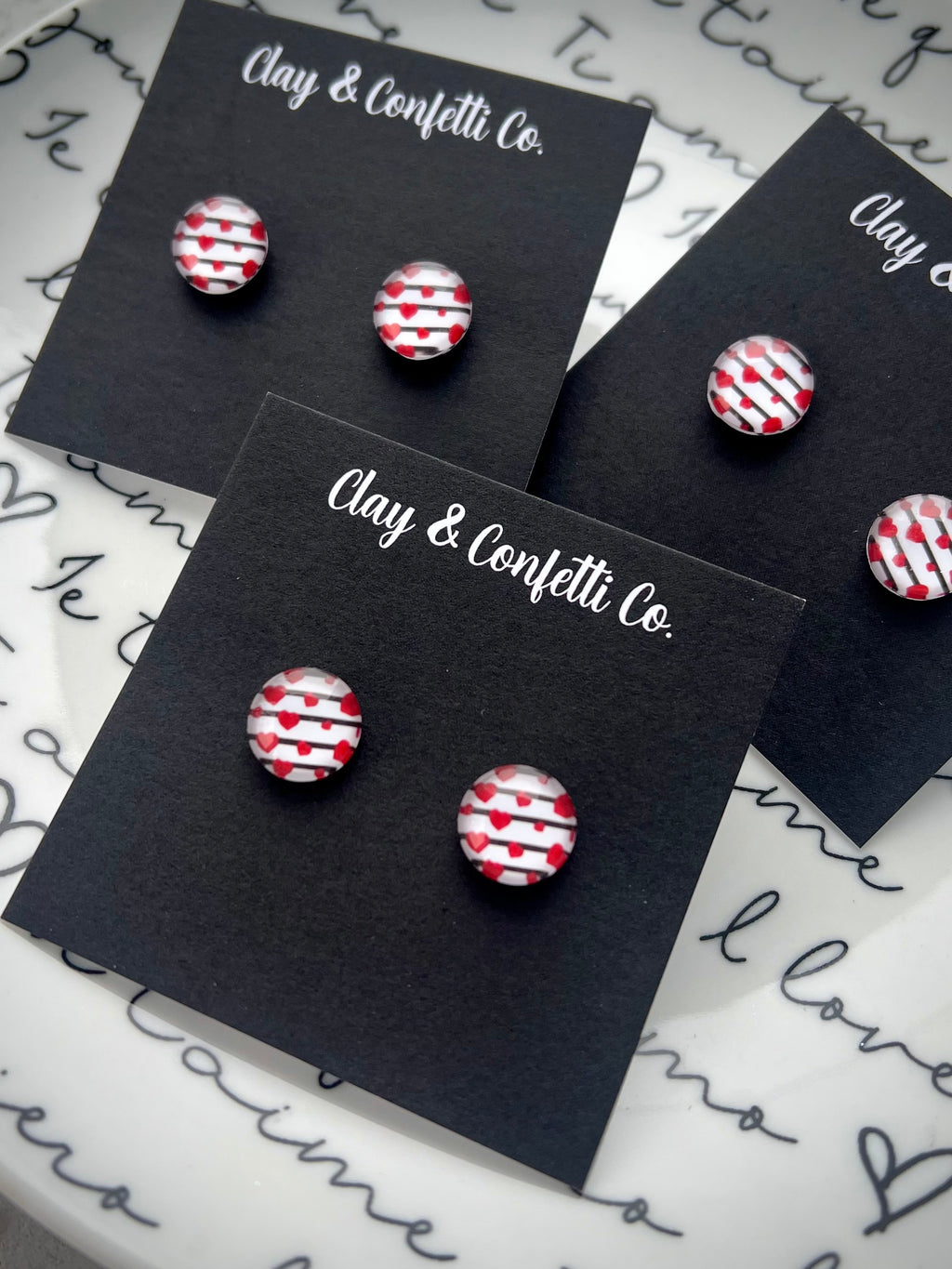 Black lines with floating hearts glass stud