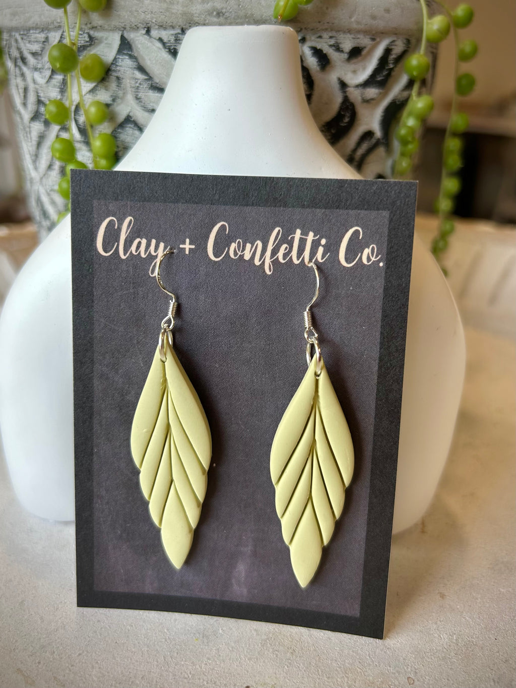 Grey feather , coral feather , light pale green feather