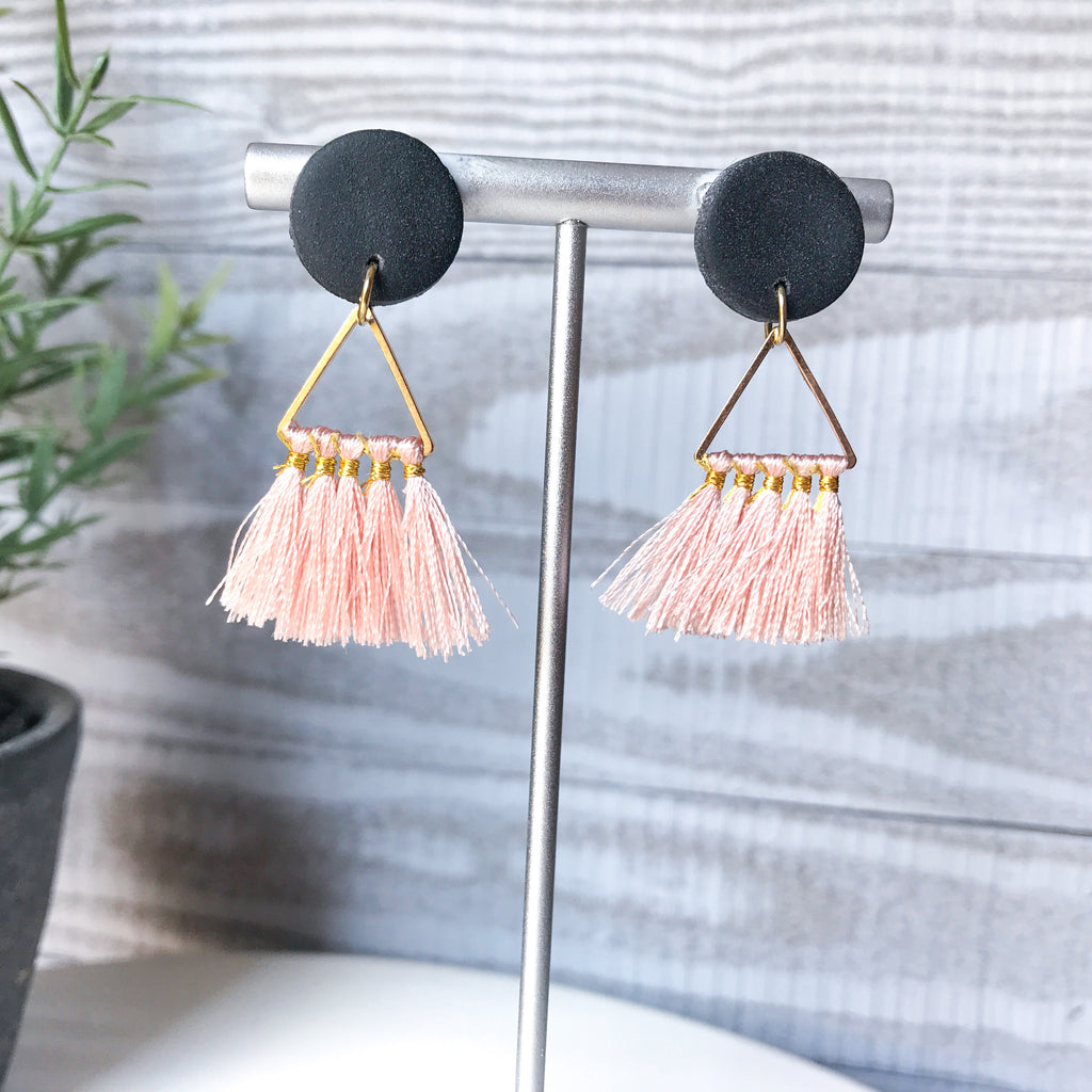 Black stud with pink tassel