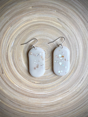 Large capsule milk glass dangle with shells